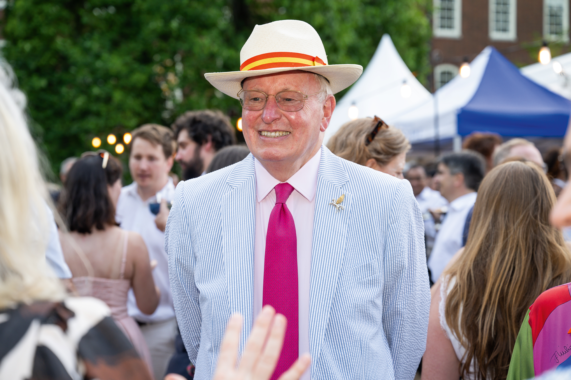 A smiling man with a straw hat on