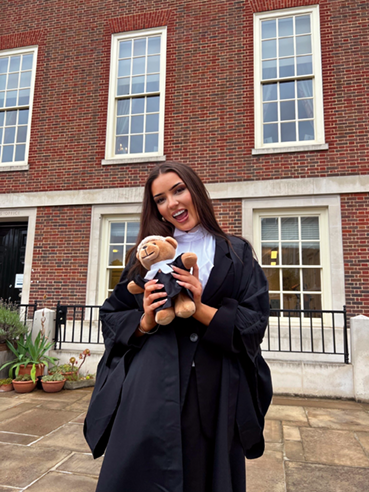 Girl holding a graduation teddy bear