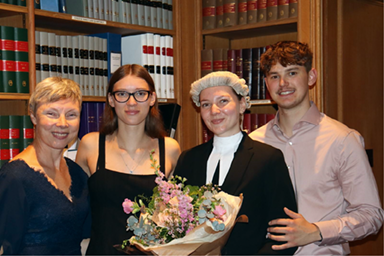 Group of people standing in library with newly appointed lawyer