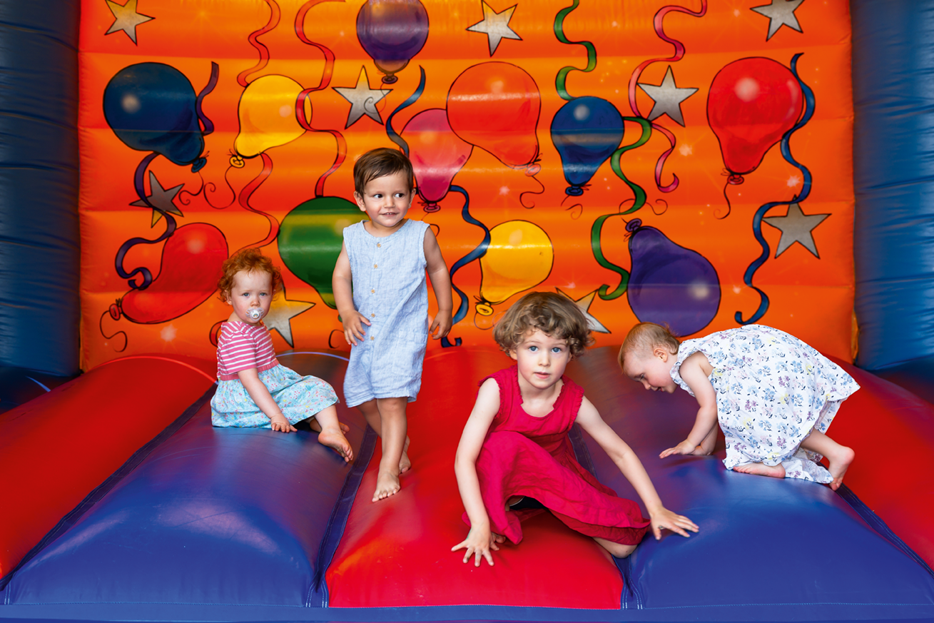 Children playing on a bouncy house