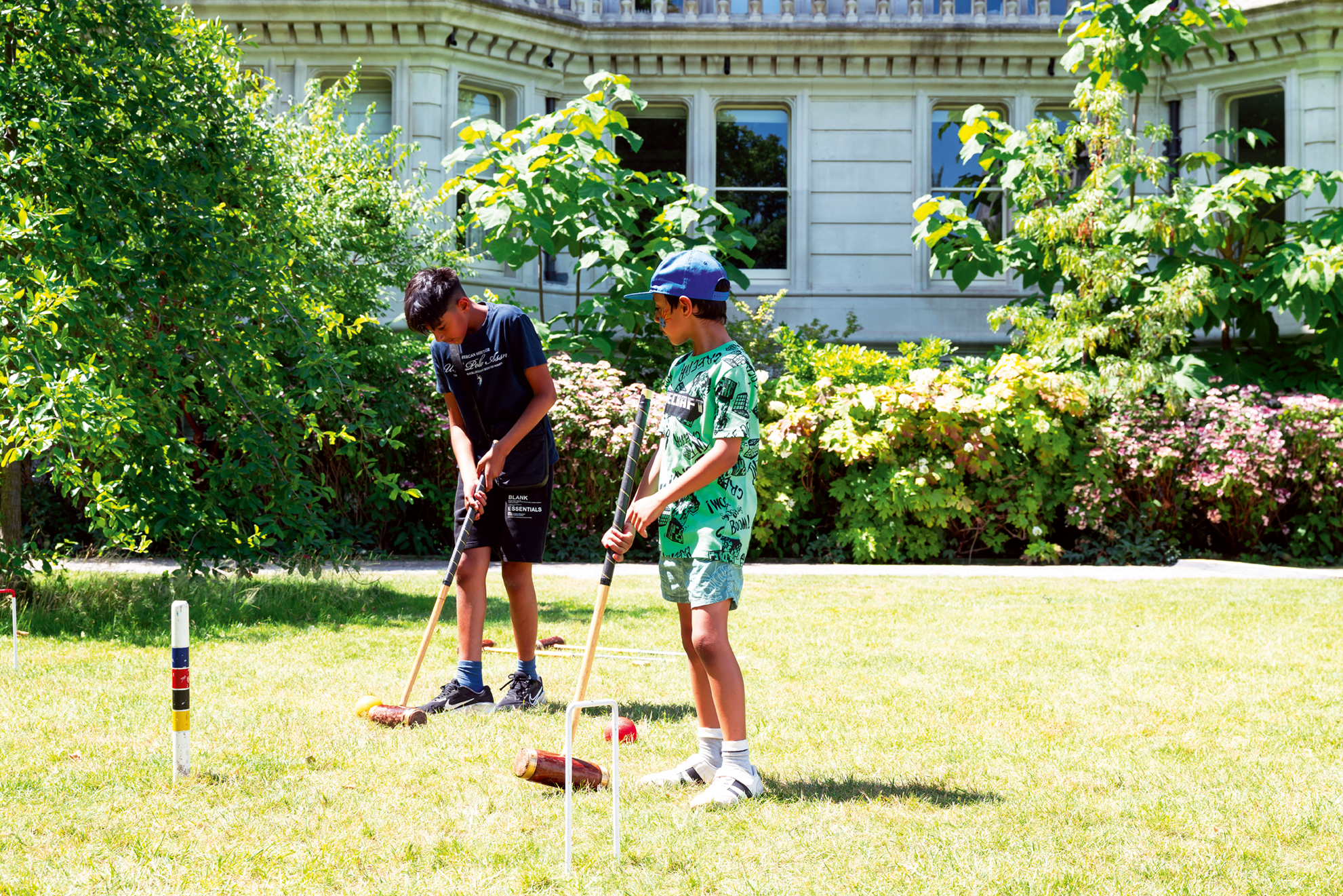Children playing croquet in the sun