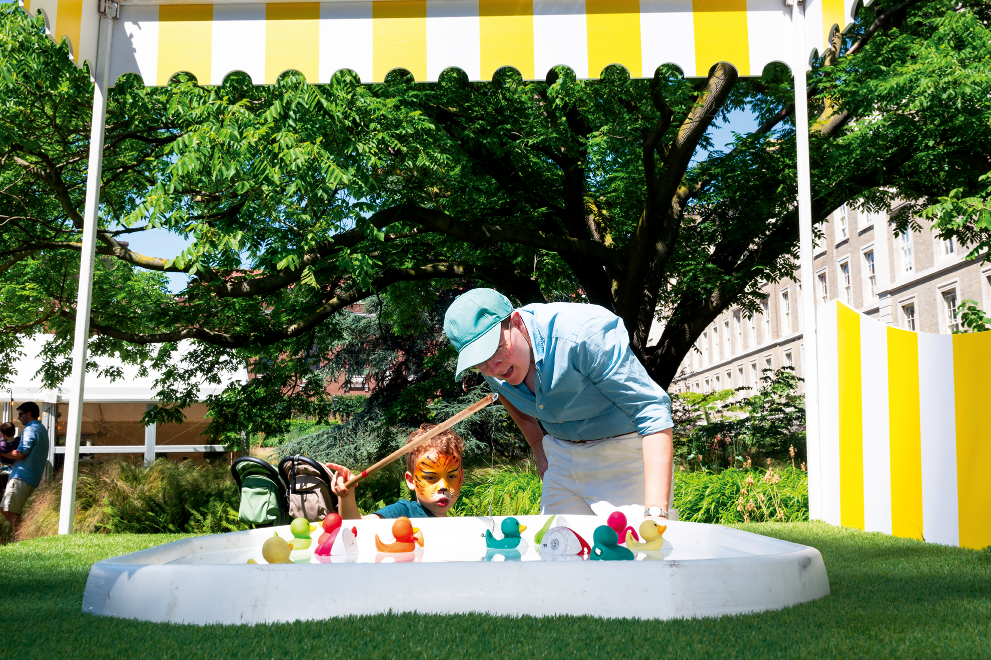 A father and son fishing for toy rubber ducks