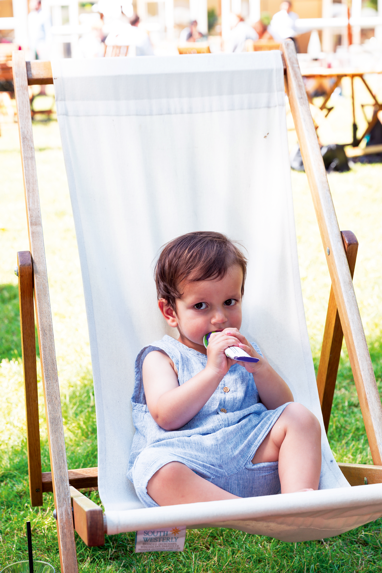 A toddler sitting on a chair eating