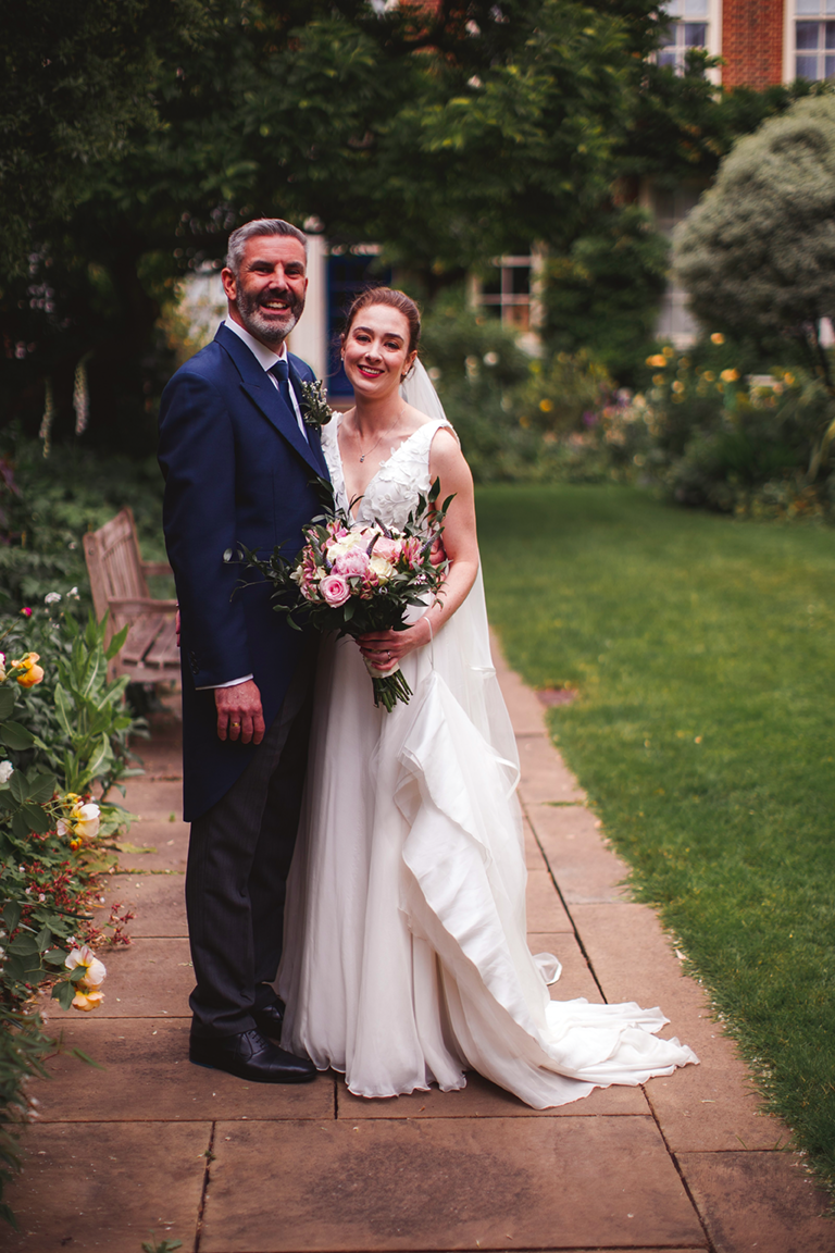 Bride and groom standing in the garden